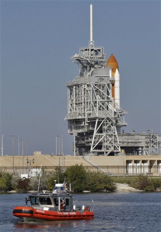 A U.S. Coast Guard boat patrols the water near the space shuttle Discovery in Cape Canaveral, Fla., Tuesday, Feb. 22, 2011. The space shuttle Discovery is scheduled to lift off Thursday afternoon on on its final voyage, an 11-day mission to the international space station. 